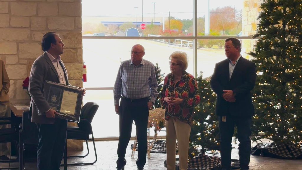 Mr. and Mrs. Johnson receive award from Ford for 40 years of dedicated service.